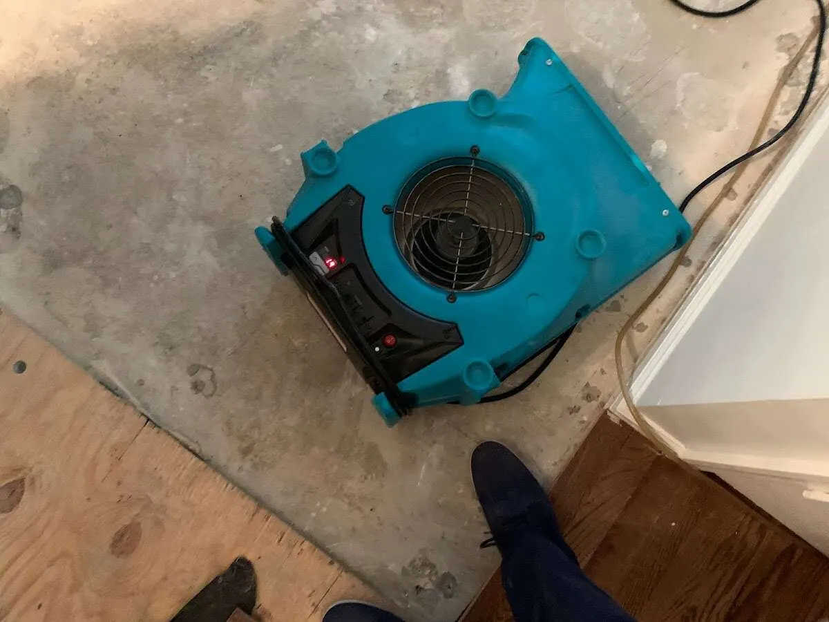 Air mover drying subfloor during Commercial Water Damage Restoration in Clemson University